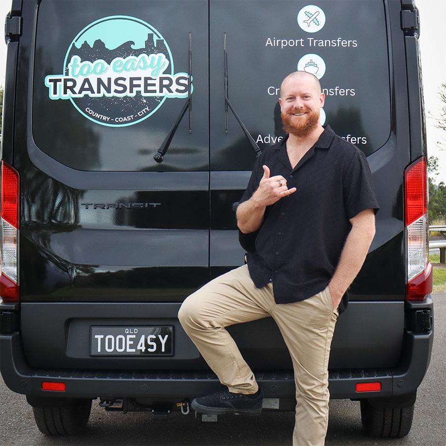 Luke standing in front of the Too Easy Transfers van
